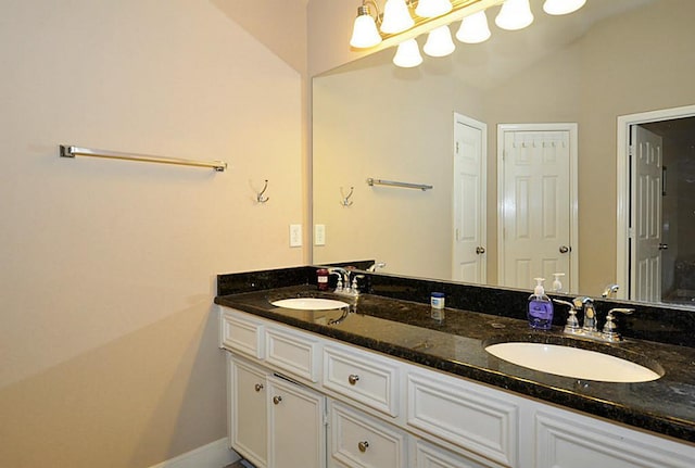 2366 Bastrop St, Houston, TX 77004 - full bath with double vanity, lofted ceiling, and baseboards