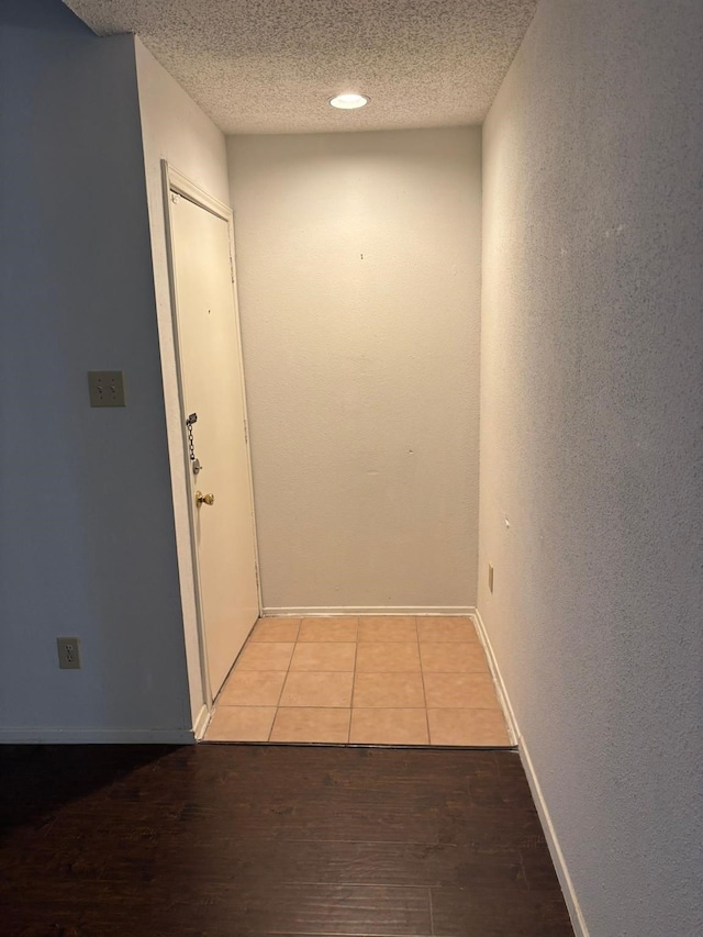 10049 Westpark Dr Unit 120, Houston, TX 77042 - corridor with wood finished floors, a textured ceiling, and baseboards