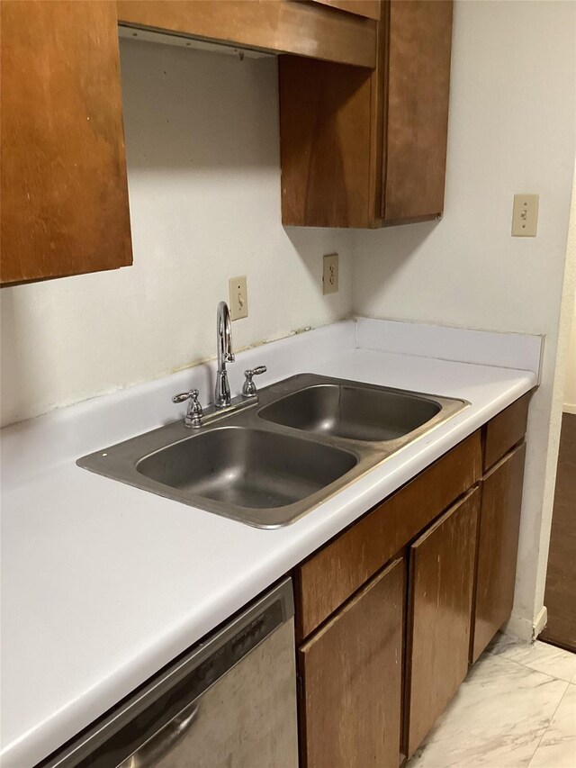 10049 Westpark Dr Unit 120, Houston, TX 77042 - kitchen with stainless steel dishwasher, a sink, light countertops, and light marble finish floors
