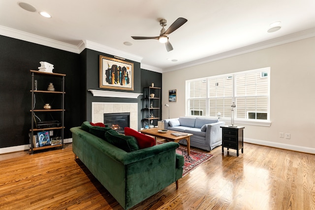 1221 W 25th St Unit D, Houston, TX 77008 - living area with ceiling fan, a tile fireplace, ornamental molding, wood finished floors, and baseboards
