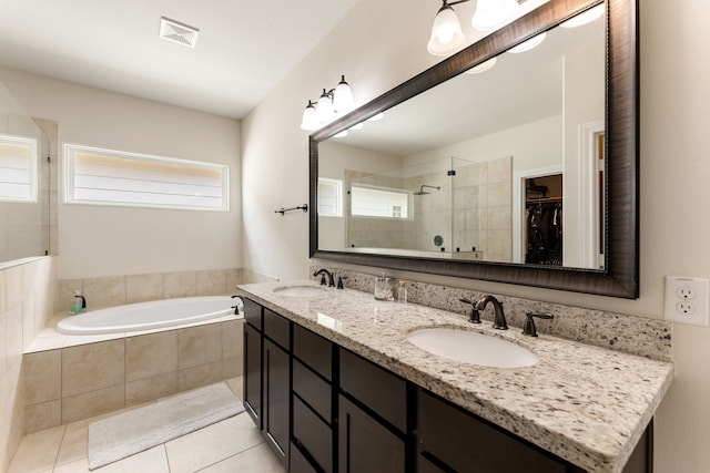 1221 W 25th St Unit D, Houston, TX 77008 - bathroom featuring a garden tub, double vanity, tiled shower, tile patterned flooring, and a spacious closet