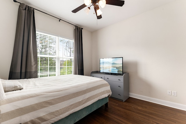 1221 W 25th St Unit D, Houston, TX 77008 - bedroom with baseboards, dark wood-style flooring, and a ceiling fan