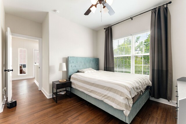1221 W 25th St Unit D, Houston, TX 77008 - bedroom with dark wood finished floors, baseboards, and a ceiling fan
