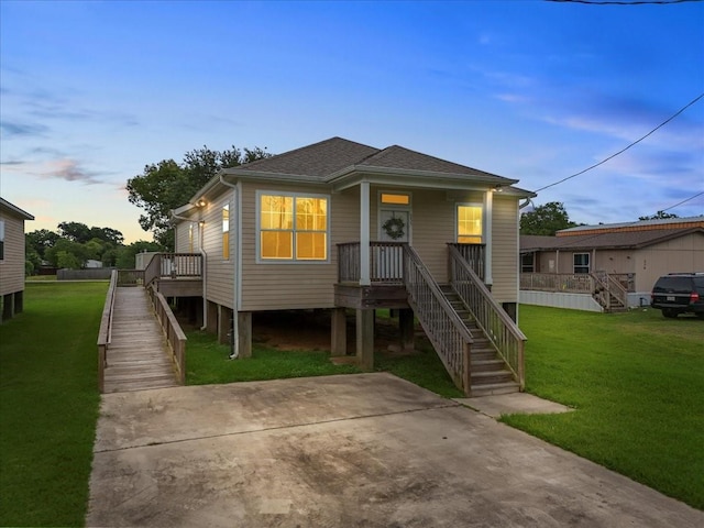 335 6th St, San Leon, TX 77539 - view of front of home featuring stairway, a yard, and roof with shingles