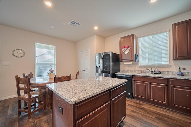 23834 Thistle Spud Ln, Hockley, TX 77447 - kitchen featuring stainless steel refrigerator with ice dispenser, dishwasher, dark wood-style floors, a sink, and light stone countertops