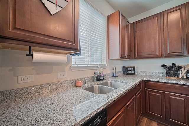 23834 Thistle Spud Ln, Hockley, TX 77447 - kitchen featuring a sink, light stone counters, and dark wood-type flooring