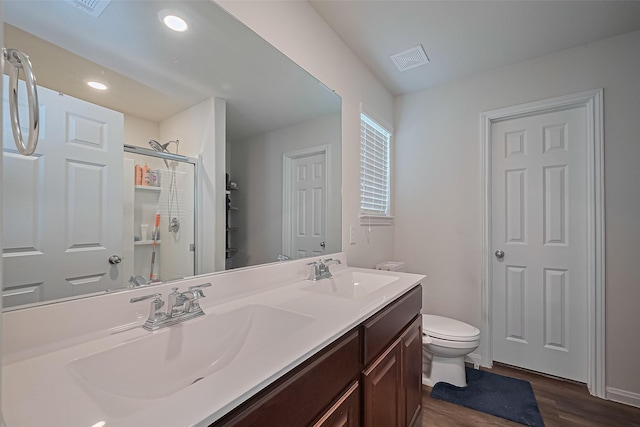 23834 Thistle Spud Ln, Hockley, TX 77447 - full bathroom with toilet, wood finished floors, double vanity, a shower stall, and recessed lighting