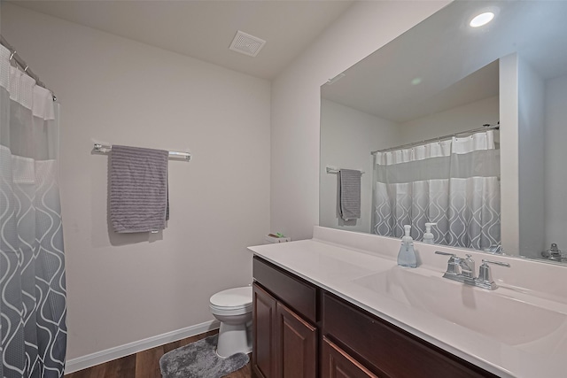 23834 Thistle Spud Ln, Hockley, TX 77447 - full bath featuring wood finished floors, vanity, toilet, and baseboards