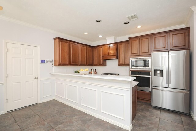 4256 Childress St, Houston, TX 77005 - kitchen with stainless steel appliances, a peninsula, ornamental molding, recessed lighting, and light countertops
