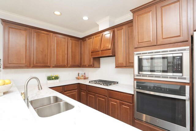 4256 Childress St, Houston, TX 77005 - kitchen featuring stainless steel appliances, a sink, recessed lighting, brown cabinetry, and crown molding