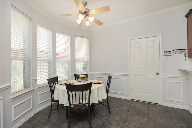 4256 Childress St, Houston, TX 77005 - dining room with a ceiling fan, crown molding, a decorative wall, a wainscoted wall, and dark tile patterned flooring