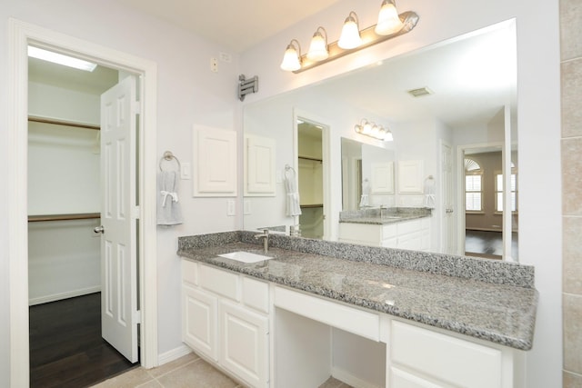 4256 Childress St, Houston, TX 77005 - bathroom featuring a spacious closet, vanity, and baseboards