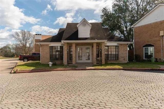 1620 Wellington Pl Unit 303, Beaumont, TX 77706 - view of front of property featuring french doors and brick siding