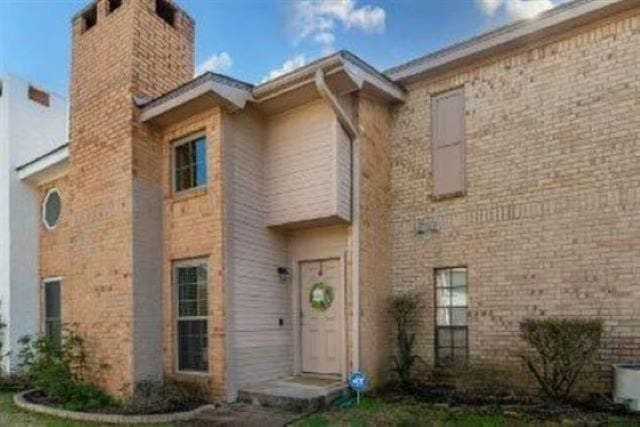 1620 Wellington Pl Unit 303, Beaumont, TX 77706 - view of front of house with a chimney and brick siding