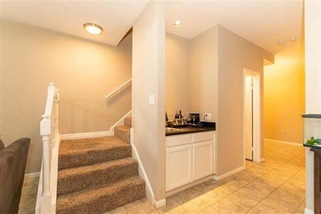 1620 Wellington Pl Unit 303, Beaumont, TX 77706 - staircase featuring wet bar