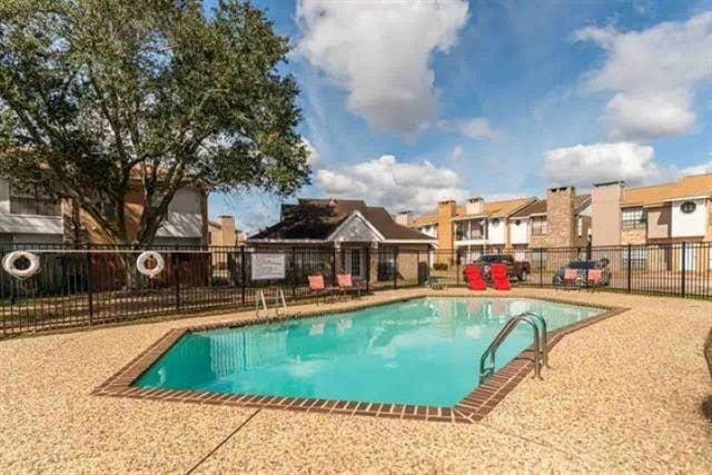 1620 Wellington Pl Unit 303, Beaumont, TX 77706 - community pool featuring a residential view