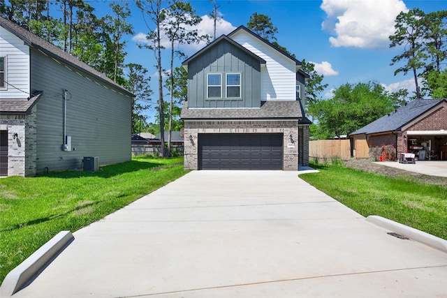 1452 Glenoaks Dr, Conroe, TX 77385 - view of front of home featuring board and batten siding, brick siding, central air condition unit, a garage, and concrete driveway