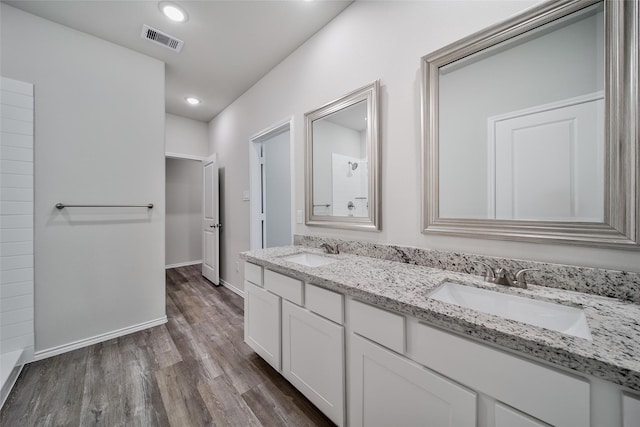 1452 Glenoaks Dr, Conroe, TX 77385 - full bathroom featuring double vanity, wood finished floors, baseboards, and recessed lighting