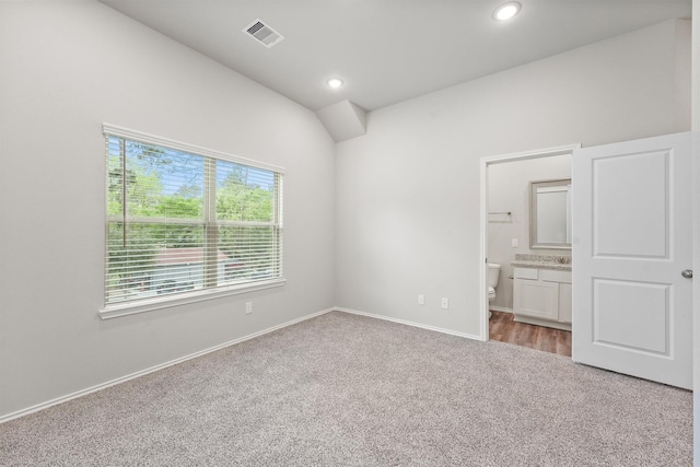 705 Little River Dr, Montgomery, TX 77316 - unfurnished bedroom featuring carpet, vaulted ceiling, ensuite bath, baseboards, and recessed lighting