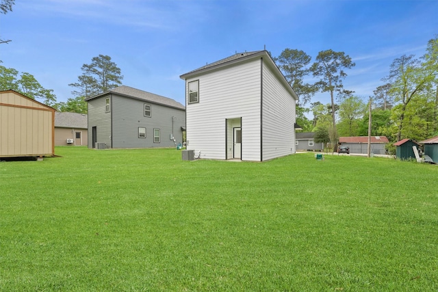 705 Little River Dr, Montgomery, TX 77316 - rear view of property with a yard and central AC unit