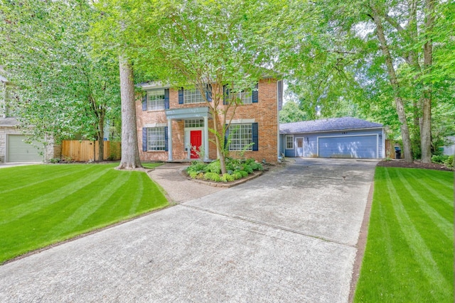 263 S Crimson Clover Ct, The Woodlands, TX 77381 - colonial-style house with a garage, a balcony, driveway, and brick siding
