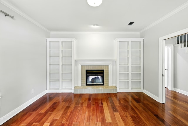 263 S Crimson Clover Ct, The Woodlands, TX 77381 - unfurnished living room featuring wood finished floors, ornamental molding, and a fireplace