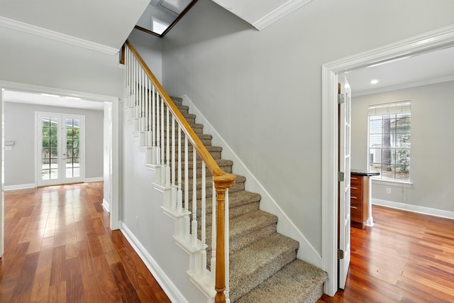 263 S Crimson Clover Ct, The Woodlands, TX 77381 - stairway featuring hardwood / wood-style floors, ornamental molding, and french doors