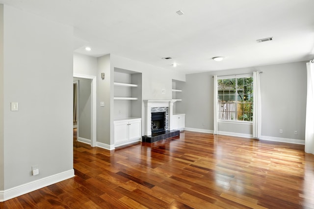 263 S Crimson Clover Ct, The Woodlands, TX 77381 - unfurnished living room with built in shelves, wood finished floors, a fireplace, and recessed lighting