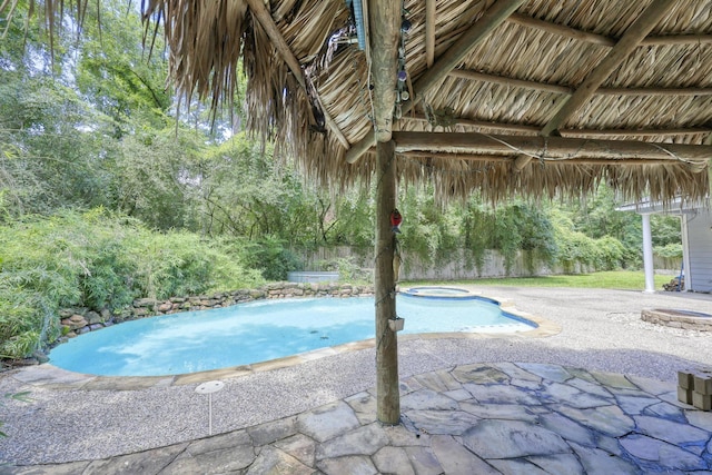 263 S Crimson Clover Ct, The Woodlands, TX 77381 - swimming pool featuring an in-ground hot tub and a patio area