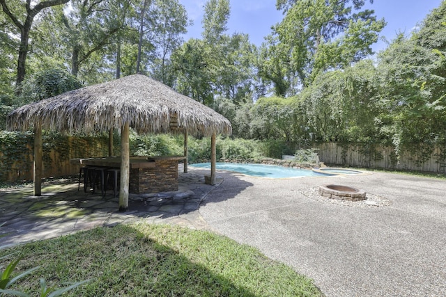 263 S Crimson Clover Ct, The Woodlands, TX 77381 - view of pool with an outdoor fire pit, a patio area, and a fenced backyard