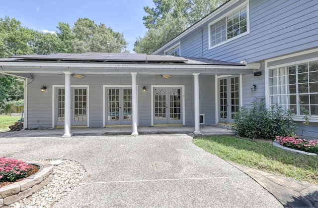 263 S Crimson Clover Ct, The Woodlands, TX 77381 - back of property with french doors, ceiling fan, solar panels, and a patio