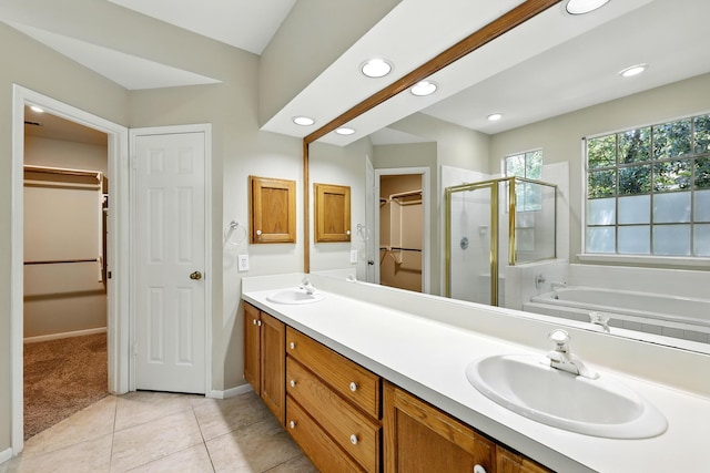 263 S Crimson Clover Ct, The Woodlands, TX 77381 - bathroom with a stall shower, double vanity, a bath, a walk in closet, and recessed lighting