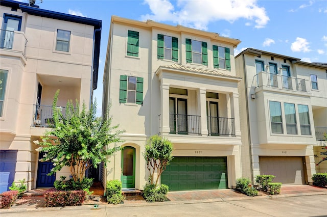 9617 Pemberton Crescent Dr, Houston, TX 77025 - multi unit property with an attached garage, stucco siding, driveway, and a balcony