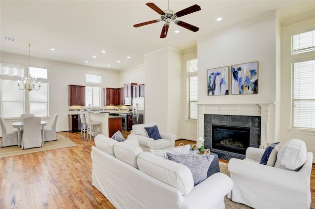 9617 Pemberton Crescent Dr, Houston, TX 77025 - living area with light wood-style floors, ceiling fan, crown molding, recessed lighting, and a chandelier