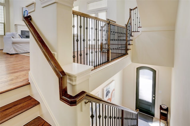 9617 Pemberton Crescent Dr, Houston, TX 77025 - stairs with wood finished floors, a towering ceiling, and arched walkways