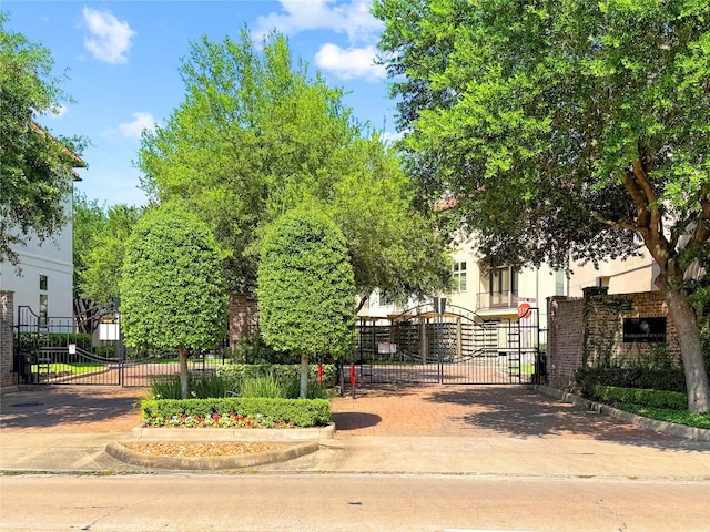9617 Pemberton Crescent Dr, Houston, TX 77025 - view of front of property with a gate, stucco siding, and decorative driveway