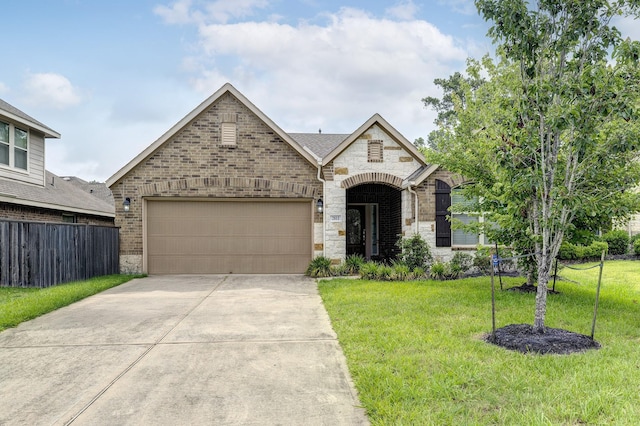 2811 Ridgecliff Ct, Conroe, TX 77301 - french provincial home with stone siding, driveway, an attached garage, and brick siding
