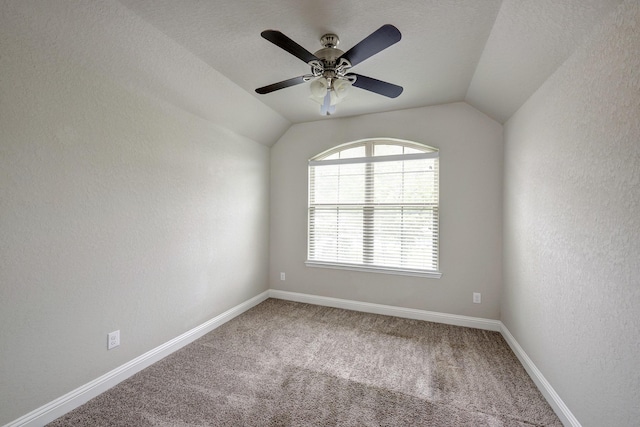 2811 Ridgecliff Ct, Conroe, TX 77301 - carpeted empty room featuring lofted ceiling, a ceiling fan, baseboards, and a textured wall