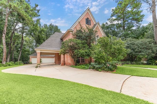 6010 Maple Knob Ct, Kingwood, TX 77345 - view of front facade featuring brick siding, an attached garage, a front yard, and driveway
