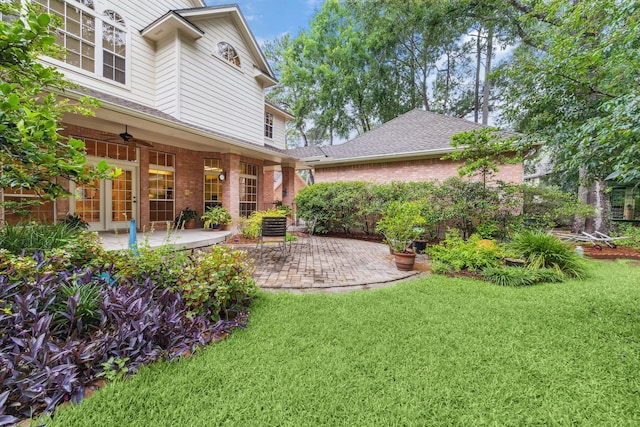 6010 Maple Knob Ct, Kingwood, TX 77345 - view of grassy yard featuring a patio, a ceiling fan, and french doors
