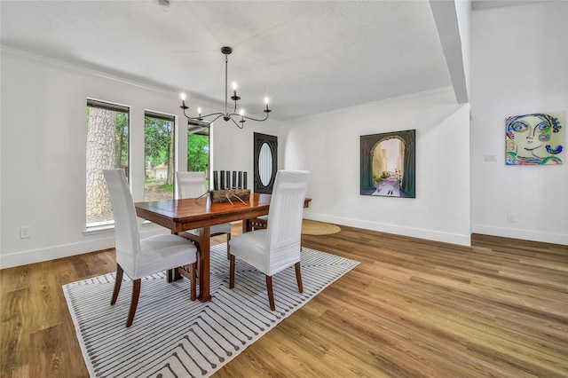 3022 Grove Terrace Dr, Houston, TX 77345 - dining area with a chandelier, crown molding, baseboards, and wood finished floors