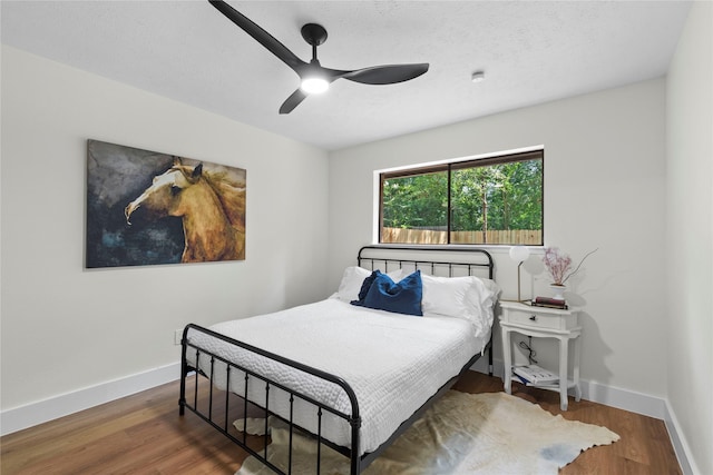 3022 Grove Terrace Dr, Houston, TX 77345 - bedroom with baseboards, wood finished floors, and a ceiling fan