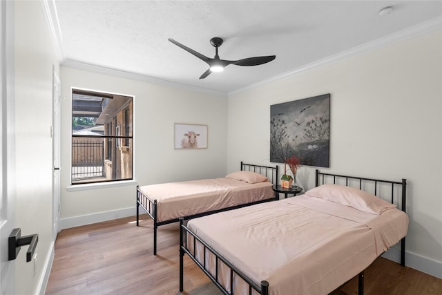 3022 Grove Terrace Dr, Houston, TX 77345 - bedroom with crown molding, wood finished floors, baseboards, and ceiling fan