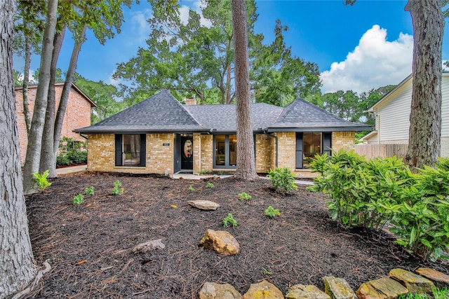 3022 Grove Terrace Dr, Houston, TX 77345 - view of front of home with a shingled roof, brick siding, and a chimney