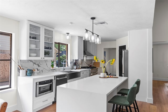 3022 Grove Terrace Dr, Houston, TX 77345 - kitchen featuring a sink, backsplash, stainless steel appliances, light countertops, and a textured ceiling