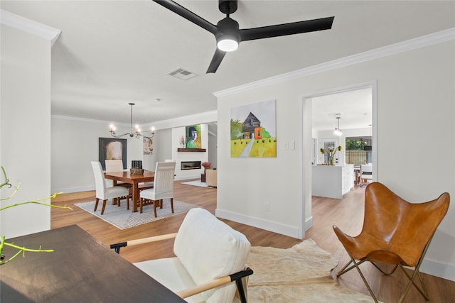 3022 Grove Terrace Dr, Houston, TX 77345 - living area with ornamental molding, light wood-type flooring, ceiling fan, a chandelier, and baseboards