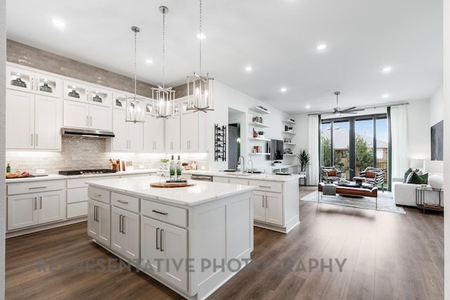 4315 Southpoint Way, Fulshear, TX 77441 - kitchen with gas cooktop, open floor plan, a center island, a peninsula, and under cabinet range hood