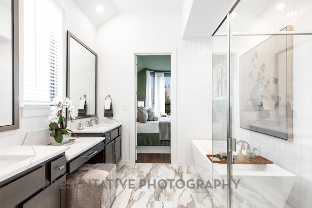 4315 Southpoint Way, Fulshear, TX 77441 - bathroom featuring two vanities, healthy amount of natural light, a freestanding bath, connected bathroom, and lofted ceiling
