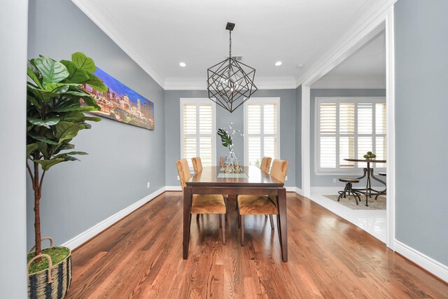 2008 Helena St, Houston, TX 77002 - dining space with a chandelier, wood finished floors, crown molding, baseboards, and recessed lighting