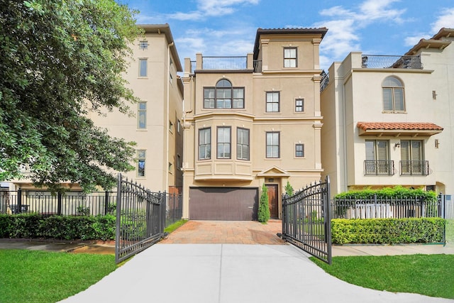 2008 Helena St, Houston, TX 77002 - view of front of house with stucco siding, decorative driveway, a gate, and an attached garage